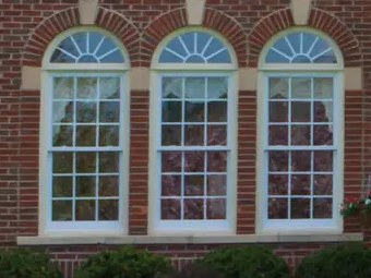 Artisan Series arch-top windows on a brick home